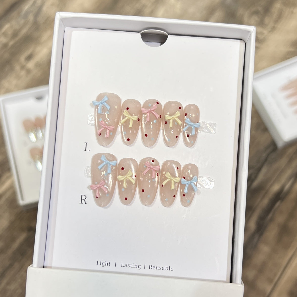 Dekoratives Press-On-Nagelset mit charmantem Bogen und Punkten Brehn