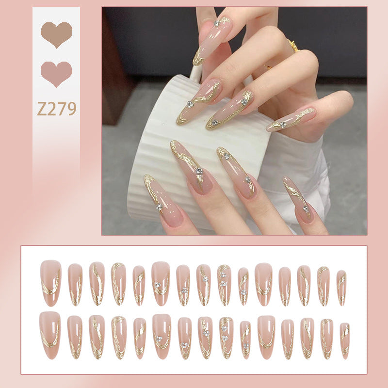 Kunstnagelset mit elegantem Gold-Design und funkelnden Applikationen Brehn