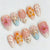 Kunstnagelset mit filigranen Blüten- und Glitzerdetails Brehn