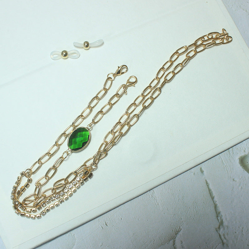 Elegante Kette mit Grünem Stein und Goldenen Akzenten Brehn