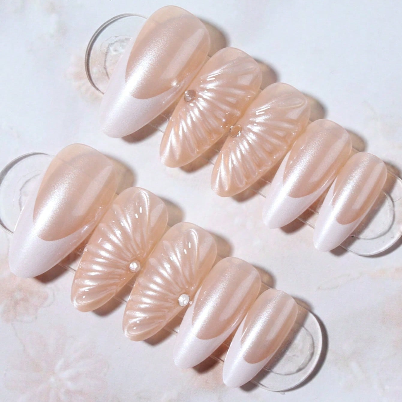 Kunstnagelset mit eleganten Muschelmuster und Glitzerakzenten Brehn