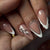 Kunstnagelset mit eleganten Spitzen und Glitzer-Akzenten Brehn