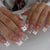 Kunstnagelset mit Glitzerakzenten und dekorativen Schleifen Brehn