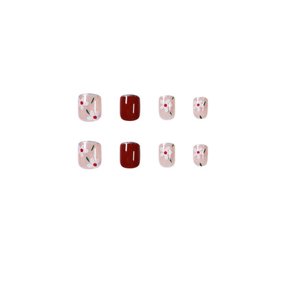 Kunstvolle Nagelkunst mit floralen Motiven und Glitzerakzenten Brehn