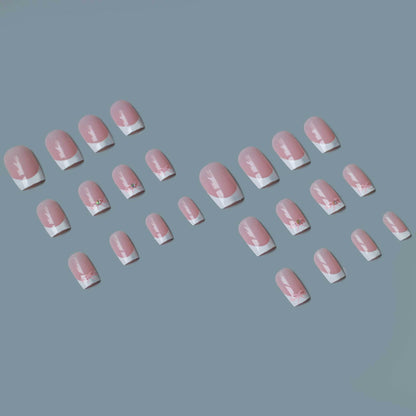 Elegantes French Tip Nagelkunstset mit zarten Schleifenakzenten