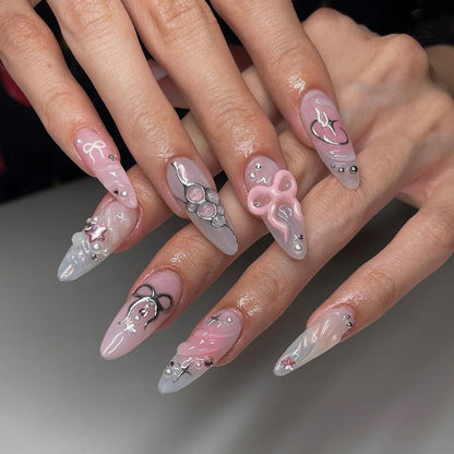 Kunstvolle Stiletto-Nägel im eleganten Design mit kreativen Verzierungen Brehn
