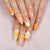 Kreatives Kunstnagelset mit floralen und Glitzerverzierungen Brehn