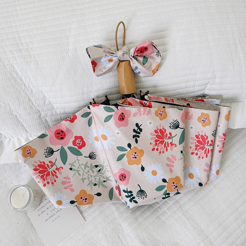 Damen Faltbarer Regenschirm mit floralem Design und niedlichen Details Brehn