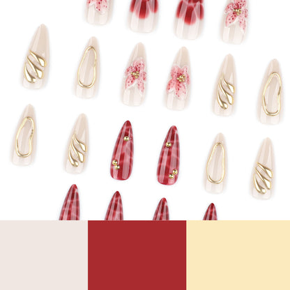 Kunstvolle Stiletto-Nägel mit eleganten Blumendesigns und Glitzerakzenten Brehn