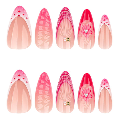 Kunstvolle Stiletto-Nägel mit floralem Design und Glitzerakzenten Brehn