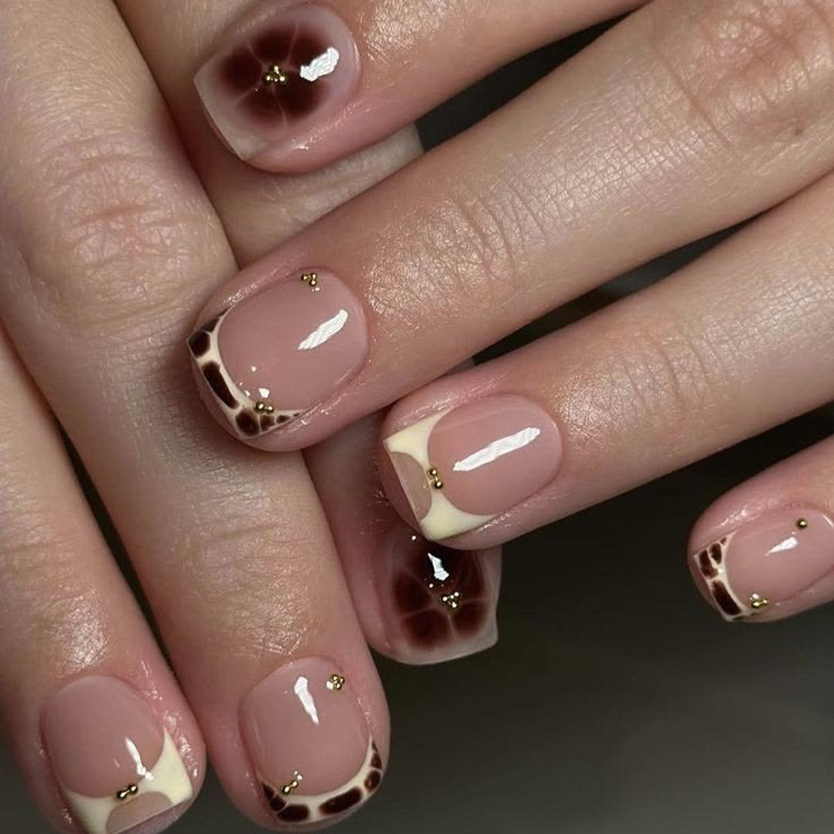 Kunstvolle Nagelverlängerungen mit elegantem Giraffenmuster und goldenen Akzenten Brehn
