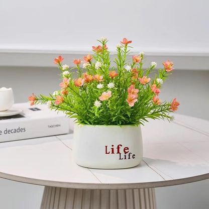 Dekorative Topfpflanzenarrangement mit Kunstblumen
