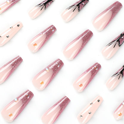 Kunstvolle Stiletto-Nägel mit floralen und glitzernden Akzenten Brehn