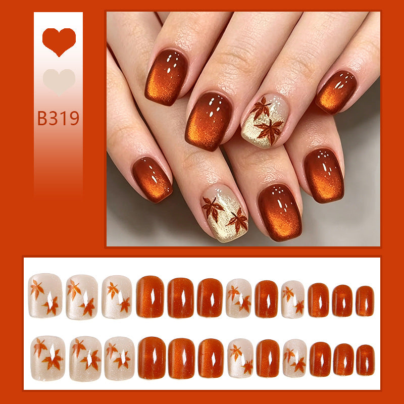 Kunstnägel mit glamourösem Ombre-Design und herbstlichen Blattanwendungen Brehn