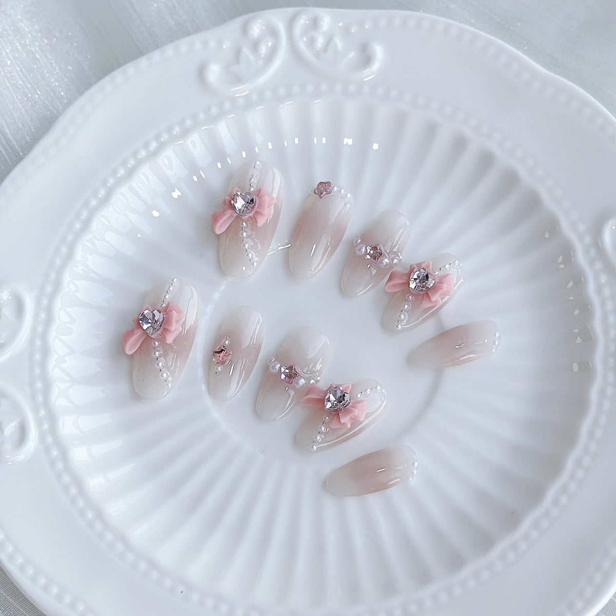 Dekoratives Acryl Press-On-Nagelset mit elegantem Bogen und Schmuckakzenten
