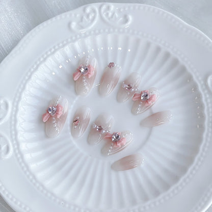 Dekoratives Acryl Press-On-Nagelset mit elegantem Bogen und Schmuckakzenten