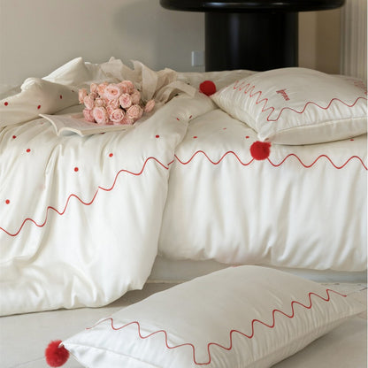 Bettwäsche-Set aus Baumwollsatin mit gewellter Stickkante und Pompon-Kissen
