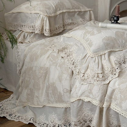 Vintage-inspirierte Baumwoll-Leinen Bettgarnitur mit großfloraler Musterung, Volant und Spitzenapplikation