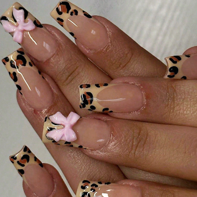 Dekorative Stiletto Press-On Nagelkunst mit Tiermotiv und Schleifenakzenten Brehn