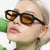 Damen quadratische Sonnenbrille mit hochglänzendem transparentem Rahmen und polarisierenden Gläsern Brehn