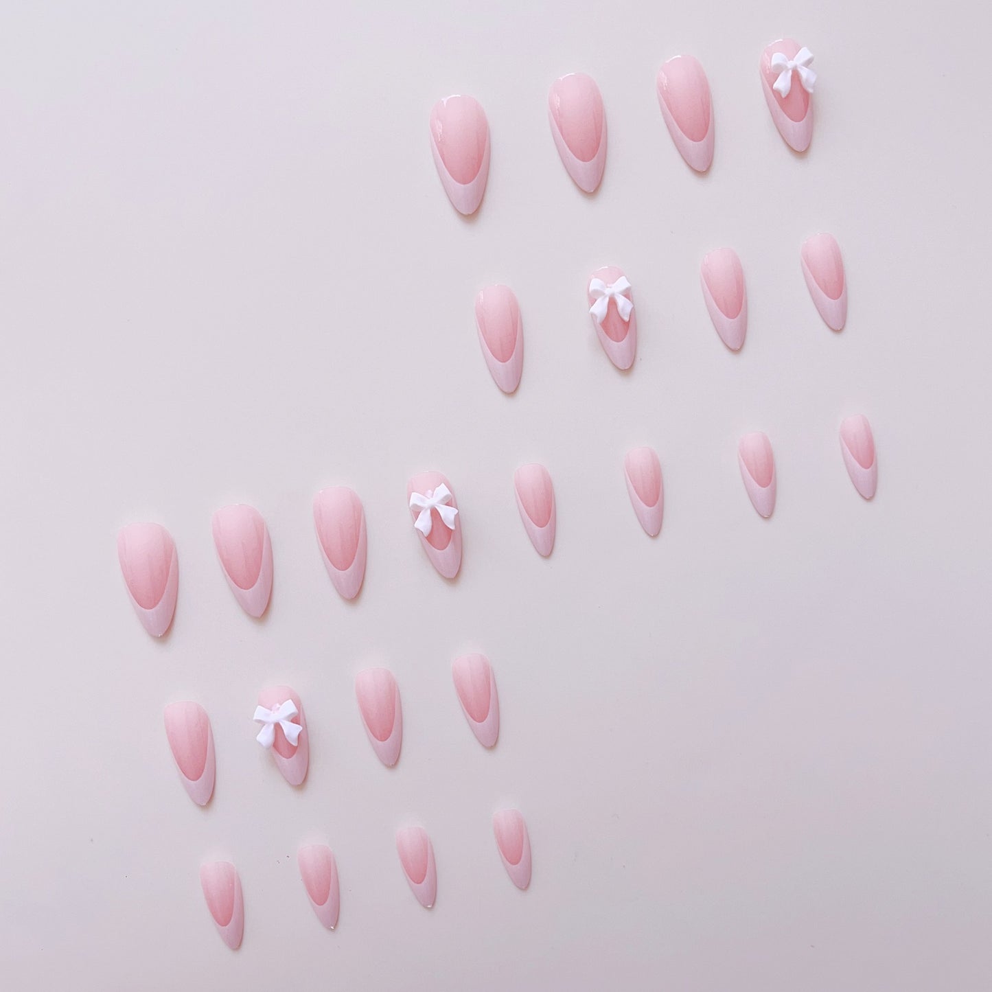 Kunstnagelset mit eleganten Spitzen und zarten Schleifenverzierungen Brehn
