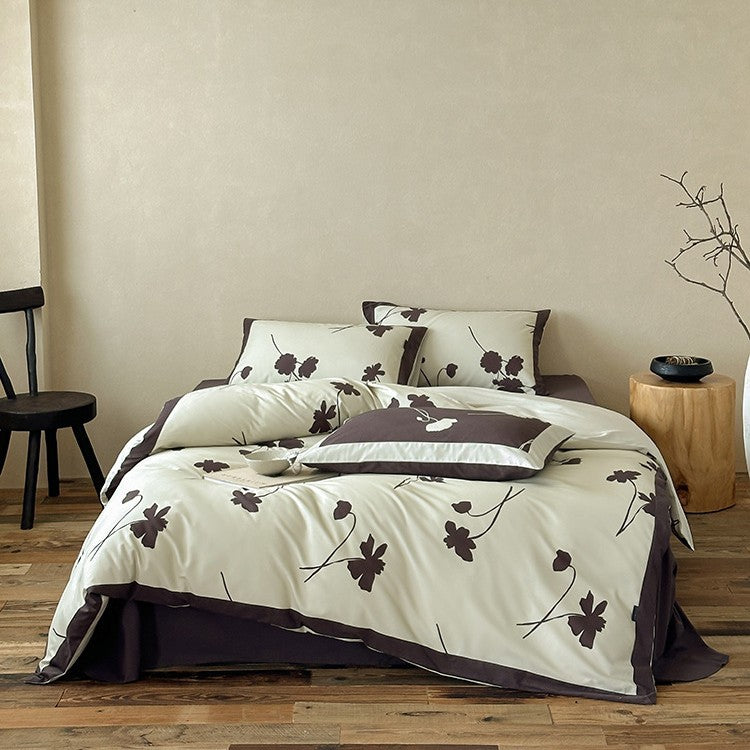 Wendbare Baumwollsatin-Bettwäschegarnitur mit floralem Silhouetten-Print und kontrastierender Kederkante