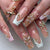 Kunstnagelset mit eleganten Blüten- und Glitzerverzierungen Brehn