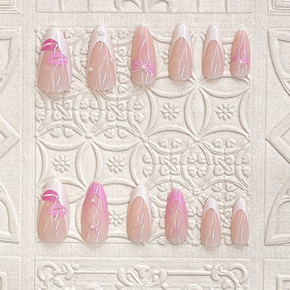 Künstlerisches Press-On Nagelset mit Kiss und Bow Design Brehn