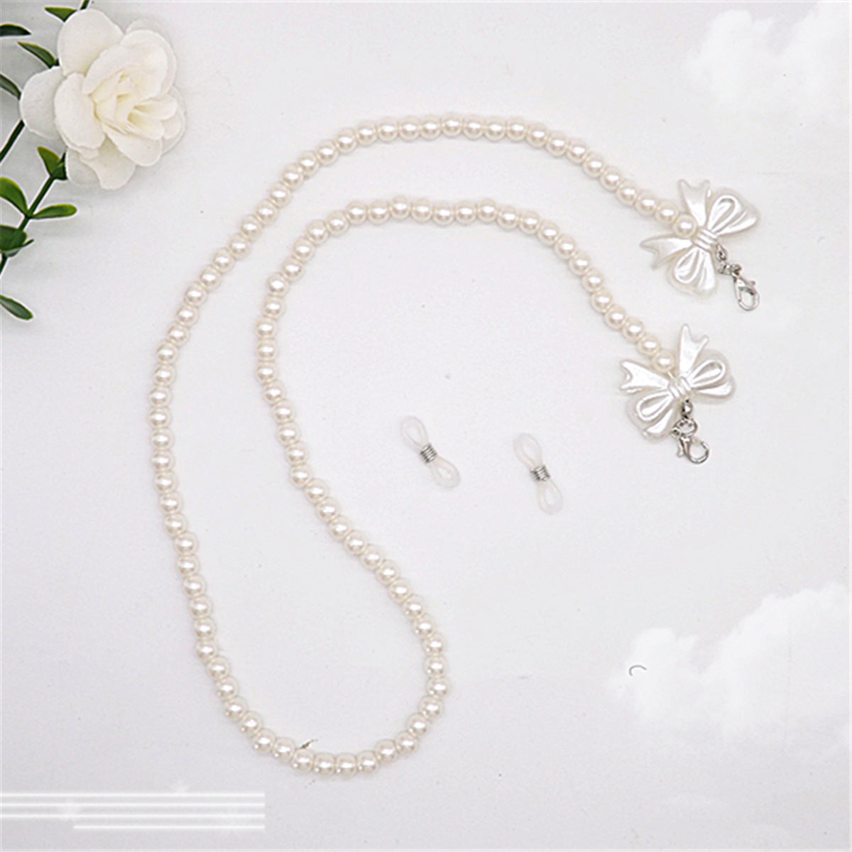 Elegante Perlen-Brillenkette mit Schleifenanhängern Brehn
