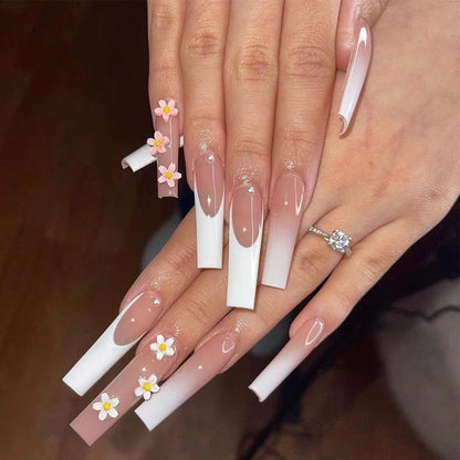 Kunstvolle Nagelverlängerungen mit elegantem Farbverlauf und kreativen Blumenakzenten Brehn