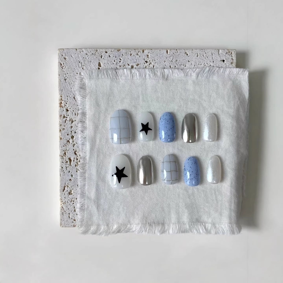 Künstlerisches Press-On-Nagelset mit geometrischen und Sternmustern