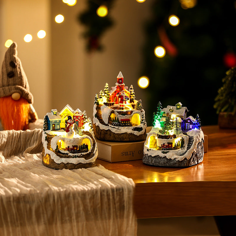 Beleuchtete Weihnachtsdorf-Szene mit Schneemann Brehn