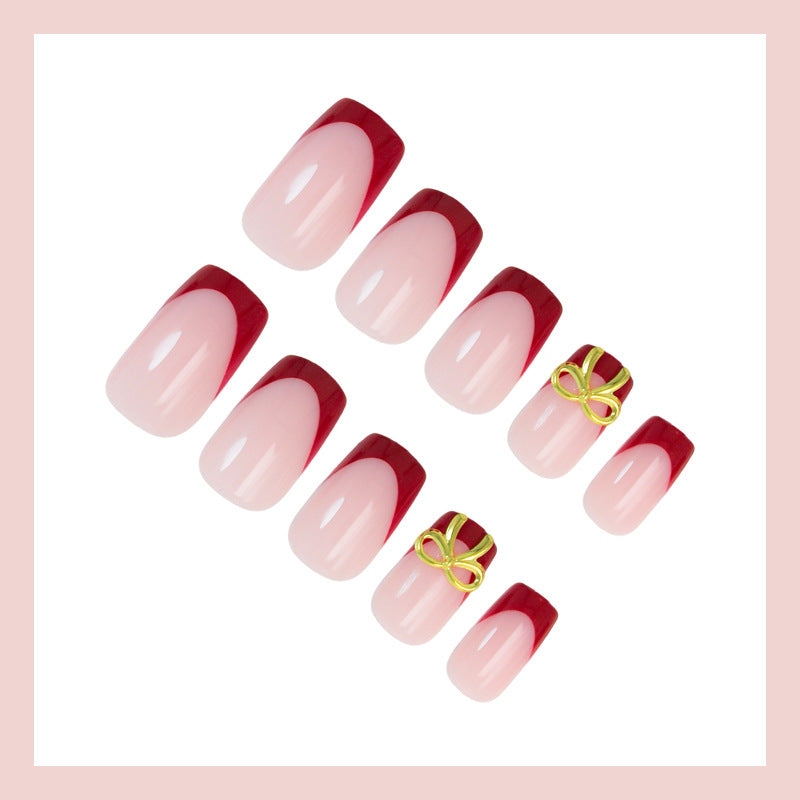 Kunstnagelset mit eleganten roten Spitzen und raffinierten Schleifenverzierungen Brehn