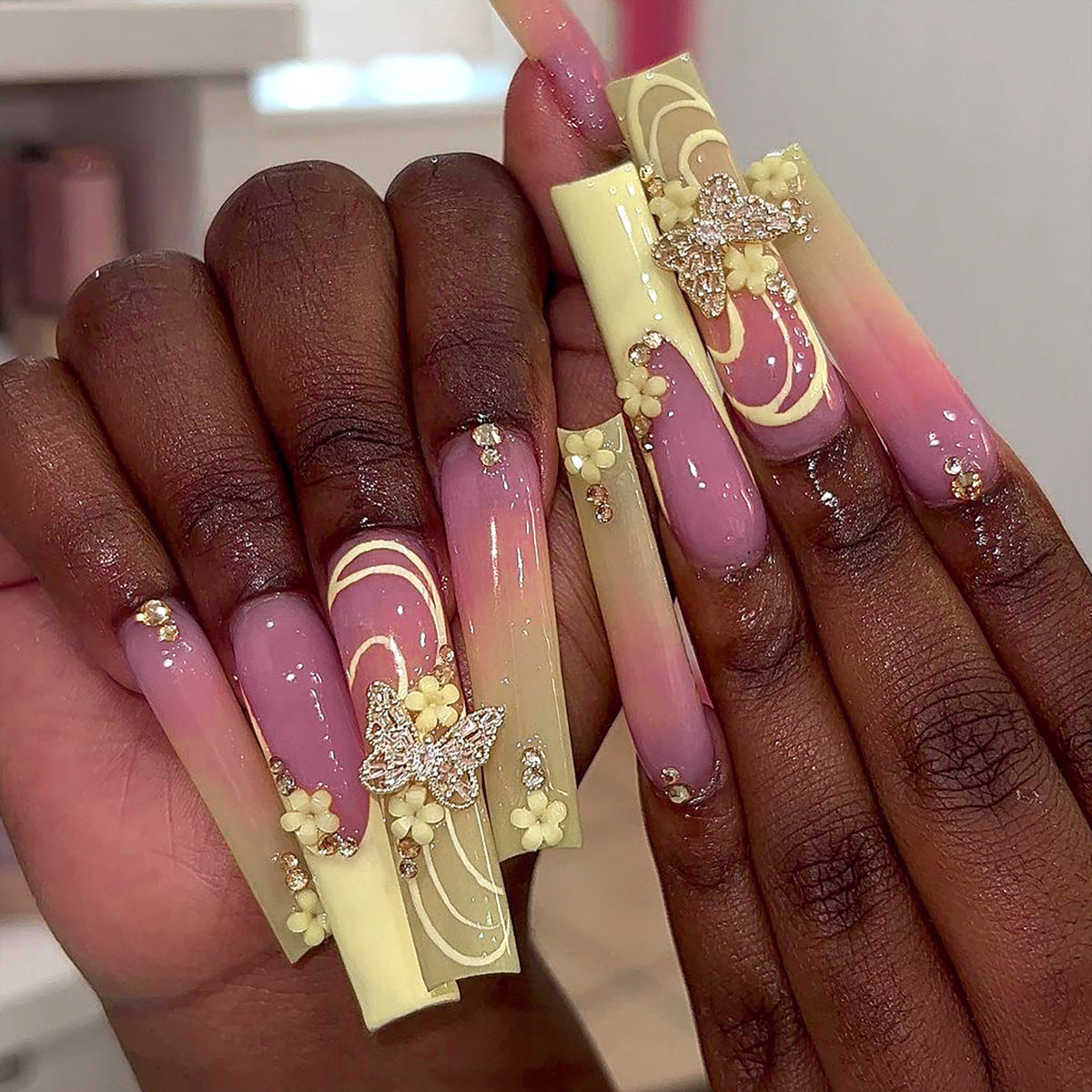 Kunstvolle Nagelkunst mit Blumen- und Schmetterlingsakzenten Brehn