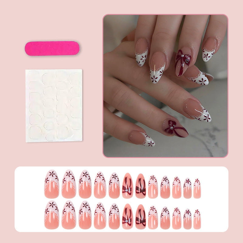 Kunstnagelset mit eleganten Schleifen- und Blumendetails Brehn