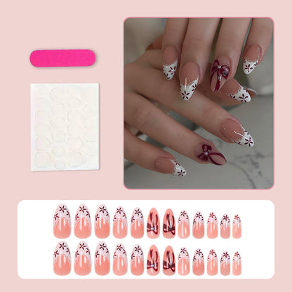 Kunstnagelset mit eleganten Schleifen- und Blumendetails Brehn
