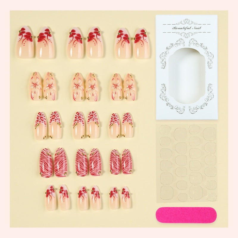 Kunstnagelset mit floralem Design und Goldakzenten Brehn