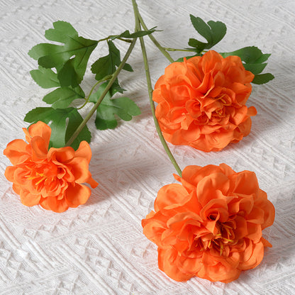 Künstliches Blumenarrangement mit Ringelblumen