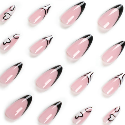 Kunstvolle Stiletto-Nägel mit elegantem Schwarz-Weiß-Design Brehn