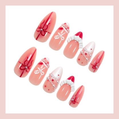 Kunstnagelset mit glamourösen Schleifen und eleganten Perlenverzierungen Brehn