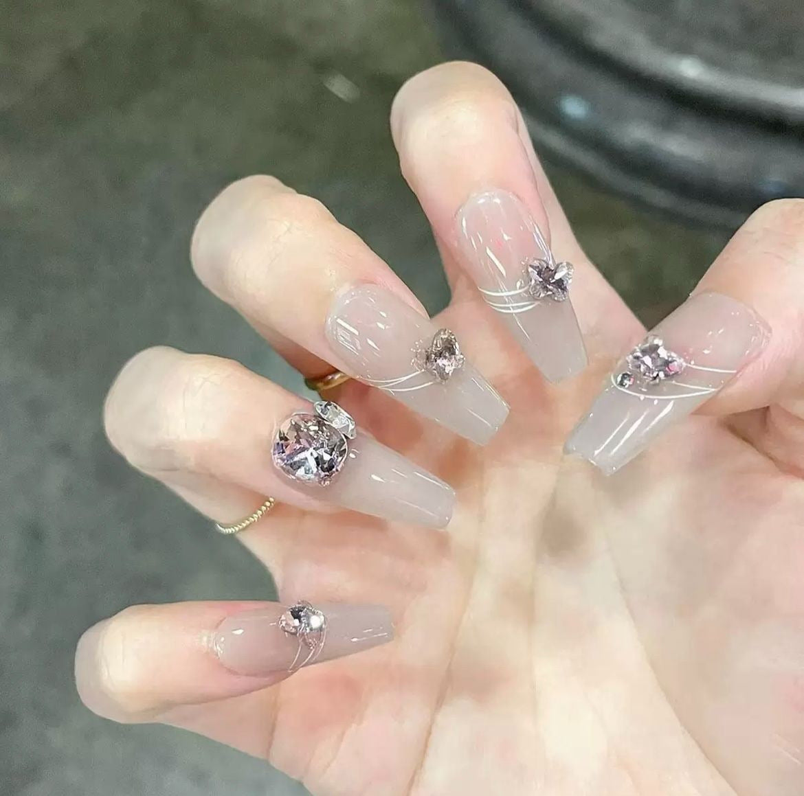 Kunstvolle Nagelkunst mit Schmetterlings- und Perlendetails Brehn