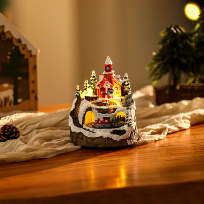 Beleuchtete Weihnachtsdorf-Szene mit Schneemann Brehn