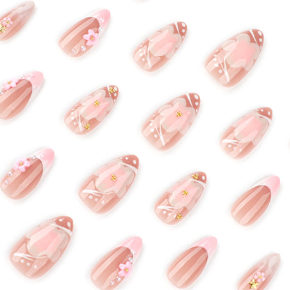 Kunstvolle Nagelverlängerungen mit Blütenmuster und Glitzerakzenten Brehn