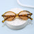 Damen modische Sonnenbrille mit ovalem Rahmen und goldenen Akzenten Brehn