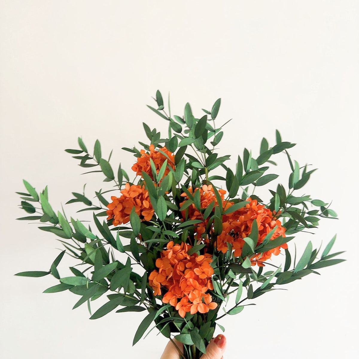 Lebensechter Blumenstrauß mit grünen Blättern