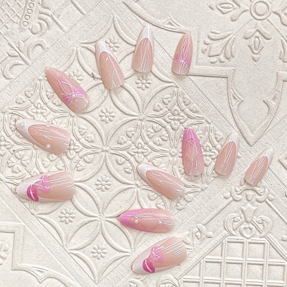 Künstlerisches Press-On Nagelset mit Kiss und Bow Design Brehn
