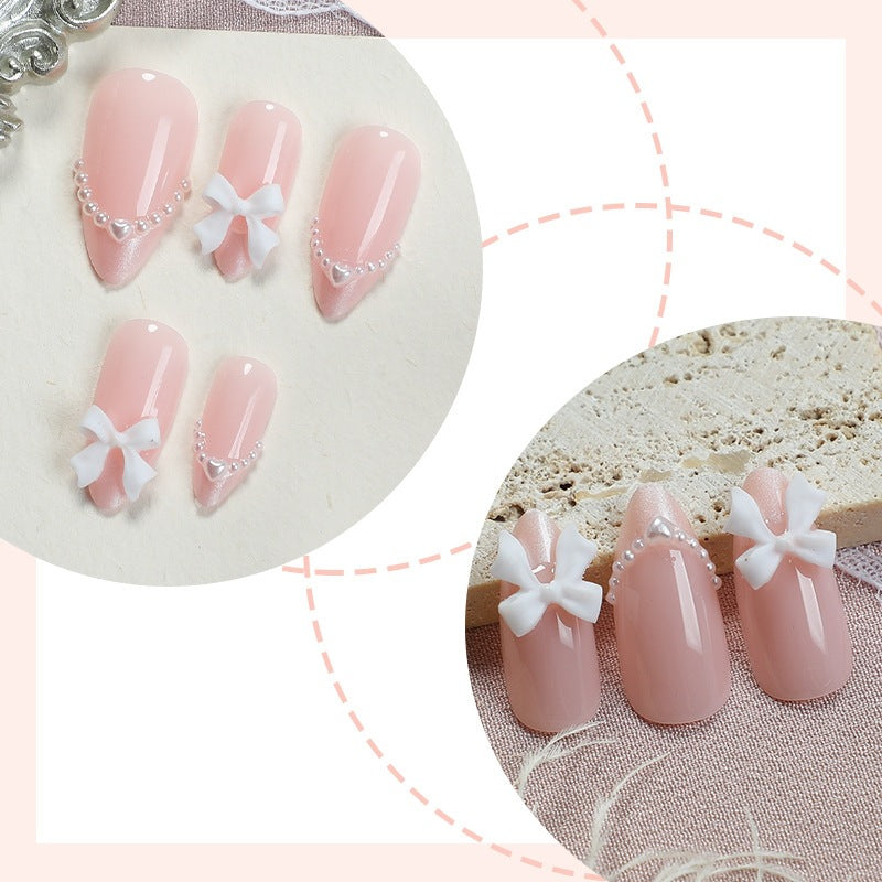 Kunstnagelset mit eleganten Schleifen und Perlen Brehn