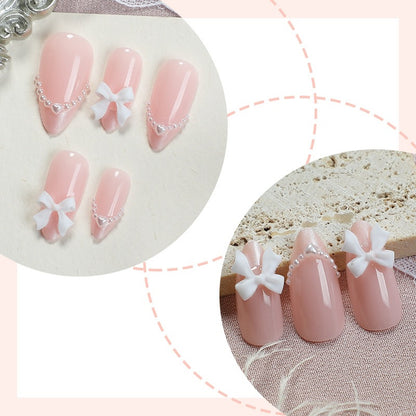 Kunstnagelset mit eleganten Schleifen und Perlen Brehn