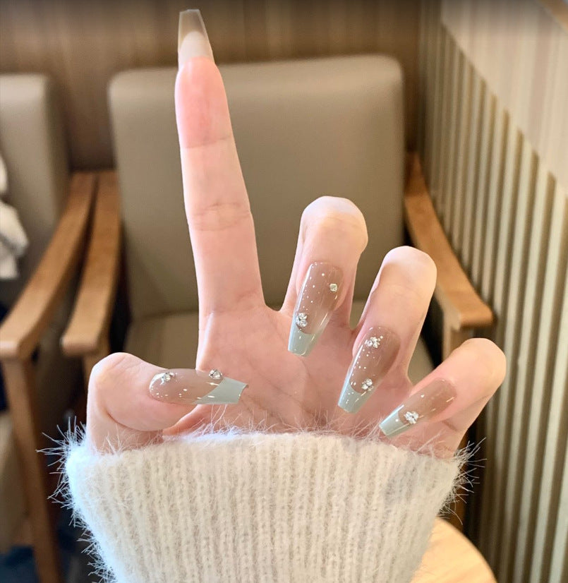 Künstlerisches Langes Stiletto Press-On Nagelset mit Schleife und Edelsteinakzenten Brehn