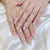 Elegantes Press-On-Nagelset mit dekorativem Bogen und Strassakzenten Brehn